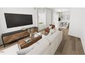 Bright and airy living room features hardwood floors and an open floor plan at 3929 Willow Gate Way, Raleigh, NC 27604