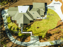 Aerial view showcasing the home's layout, including the main house, ADU, garage, porches, and parking areas, set in a landscaped yard at 1414 Whippoorwill Ln, Chapel Hill, NC 27517