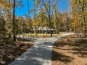Beautiful single-story home with a long, winding driveway surrounded by mature trees, offering a private and secluded setting at 1414 Whippoorwill Ln, Chapel Hill, NC 27517
