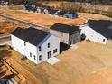 Aerial view of new homes with various siding colors and dark roofs in a community at 70 Little Creek Dr, Lillington, NC 27546