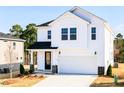 Two-story home with white siding, black door, two-car garage, and manicured lawn at 70 Little Creek Dr, Lillington, NC 27546