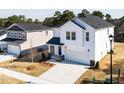 Aerial view of a two-story home with white siding, a black roof, and a two-car garage at 70 Little Creek Dr, Lillington, NC 27546