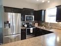Modern kitchen with stainless steel appliances and dark wood cabinets at 2704 Langstroth Ct, Franklinton, NC 27525