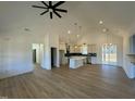 Open floor plan boasts a spacious kitchen with island, and a living room with fireplace at 8536 Savage Rd, Spring Hope, NC 27882