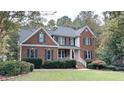 Two-story brick home with a large front yard and porch at 159 Trantham Trl, Clayton, NC 27527