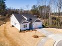 Single-story home featuring an attached two-car garage and landscaping at 326 Little Creek Dr, Lillington, NC 27546