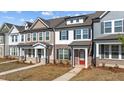 Row of two-story homes with brick facades, sidewalks and manicured lawns at 955 Alma Railway Dr # 563, Wake Forest, NC 27587
