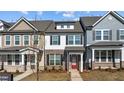 Charming two-story home with a brick facade and inviting red front door at 955 Alma Railway Dr # 563, Wake Forest, NC 27587