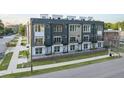 Modern townhome exterior with a mix of gray and white siding, complemented by black balconies at 10 Seawell Ave # 105, Raleigh, NC 27601