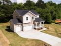 Beautiful two-story home featuring an attached two-car garage and large driveway at 240 Fast Pitch Ln, Four Oaks, NC 27524