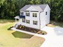 Aerial view of a beautiful two-story home with manicured lawn and a long driveway at 266 Fast Pitch Ln, Four Oaks, NC 27524