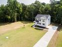 Aerial view of a beautiful two-story home with a large manicured lawn at 266 Fast Pitch Ln, Four Oaks, NC 27524