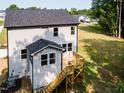 Rear exterior featuring a wood deck, siding, and several windows at 266 Fast Pitch Ln, Four Oaks, NC 27524