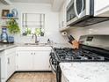 Bright kitchen featuring granite countertops, stainless steel appliances, and ample natural light at 3736 Jamestown Cir, Raleigh, NC 27609