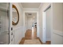 Inviting entryway with light walls, wood floors, and decorative mirror at 52 Macy Cir, Wendell, NC 27591