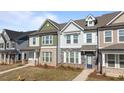 Attractive townhomes featuring coordinated exteriors and well-maintained front yards and sidewalks at 951 Alma Railway Dr # 561, Wake Forest, NC 27587