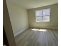 Bright and airy bedroom with modern vinyl flooring and a large window at 96 Little Creek Dr, Lillington, NC 27546