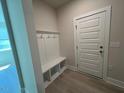 Mudroom entryway with convenient storage bench and coat hooks at 96 Little Creek Dr, Lillington, NC 27546