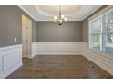 Formal dining room with elegant wainscoting, chandelier, and natural light at 98 Valley Brook Ln, Spring Lake, NC 28390