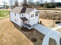 Spacious two-story house with a large driveway and expansive front yard on a sunny day at 305 Little Creek Dr, Lillington, NC 27546