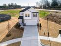 Stunning aerial view of a two-story home with a spacious driveway and a beautifully landscaped yard at 305 Little Creek Dr, Lillington, NC 27546