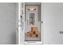 Bright foyer with white wainscoting, decorative tile flooring, and glass door at 34 Macy Cir, Wendell, NC 27591