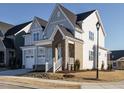 Charming two-story home featuring gray and white siding and landscaped front yard at 100 Mossy Falls Way, Wendell, NC 27591