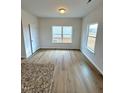 A bright dining room featuring wood-look floors, neutral paint, and large windows for plenty of natural light at 216 Bruce Dr, Dunn, NC 28334