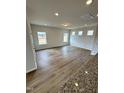 Spacious living room with wood-look floors, neutral paint, and large windows for plenty of natural light at 216 Bruce Dr, Dunn, NC 28334
