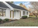 Welcoming front entrance with white brick, a black roof, and light wood columns at 234 Crumpler Rd, Kenly, NC 27542