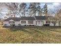 Charming single-story home with a well-manicured front lawn and mature trees in a quiet neighborhood at 234 Crumpler Rd, Kenly, NC 27542