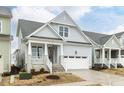 Beautiful home showcasing a welcoming porch with stone accents and a two-car garage at 1253 Barreto Dr, Wendell, NC 27591