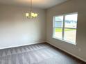 Dining room showcases neutral paint, new carpet, hanging light fixture and backyard view at 158 Citizens Ct # 32, Four Oaks, NC 27524
