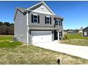 Side view of a gray, two story home featuring an attached two car garage and manicured lawn at 158 Citizens Ct # 32, Four Oaks, NC 27524
