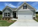 Beautiful one-story home with a two-car garage, dark shutters, and well-manicured front yard at 346 Olivia Crossing Ct # 12, Four Oaks, NC 27524