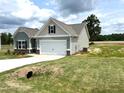 Craftsman-style home with attached garage, concrete driveway, and well-maintained lawn and landscaping at 346 Olivia Crossing Ct # 12, Four Oaks, NC 27524