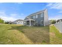 Large backyard with a covered patio and green grass, perfect for entertaining at 1301 Cricket St, Elon, NC 27244