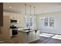 Modern eat-in kitchen features stainless steel appliances, granite countertops, and a kitchen island at 59 Mossy Bridge Ct, Lillington, NC 27546