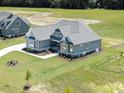 Stunning aerial view of the blue home with its large yard and well-maintained landscaping at 70 Water Willow Ln, Zebulon, NC 27597