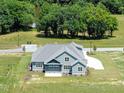Gorgeous aerial view of the property backing to trees, showcasing its spacious layout at 70 Water Willow Ln, Zebulon, NC 27597