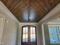 Elegant entryway featuring a stained wood ceiling and double doors at 70 Water Willow Ln, Zebulon, NC 27597