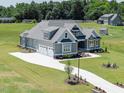 Beautiful home exterior with a three car garage and a long driveway at 70 Water Willow Ln, Zebulon, NC 27597