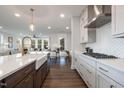 Modern kitchen with white cabinets, gas cooktop, and stylish backsplash at 964 Myers Point Dr # 41, Morrisville, NC 27560