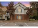 Exterior view of a townhome featuring a brick facade, second level siding and manicured landscaping at 1114 Chenille Dr # 1100, Morrisville, NC 27560