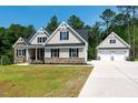 Stunning exterior view of home with attached and detached garages at 160 Purslane Dr, Franklinton, NC 27525