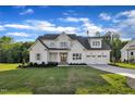 Charming two-story home featuring a lush green lawn and an attached two car garage at 27 Asti Ct, Clayton, NC 27527