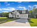 Inviting two-story home with a long driveway leading to an attached two car garage at 27 Asti Ct, Clayton, NC 27527