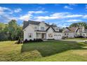 Picturesque two-story home with an expansive front lawn and an attached two car garage at 27 Asti Ct, Clayton, NC 27527