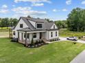 Inviting two-story home with a cozy front porch, well-kept lawn, and convenient side entry garage at 5124 Grist Stone Way, Youngsville, NC 27596