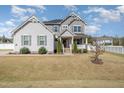 Traditional two-story home featuring a charming front porch and well-maintained landscaping at 1024 Jarrett Bay Rd, Willow Springs, NC 27592